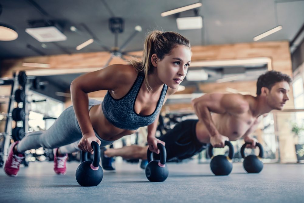 young,couple,is,working,out,at,gym.,attractive,woman,and young,couple,is,working,out,at,gym.,attractive,woman,and