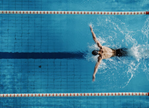 aerial,top,view,male,swimmer,swimming,in,swimming,pool.,professional