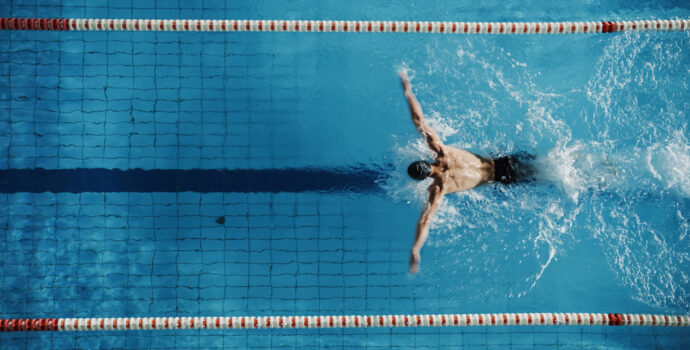 aerial,top,view,male,swimmer,swimming,in,swimming,pool.,professional aerial,top,view,male,swimmer,swimming,in,swimming,pool.,professional