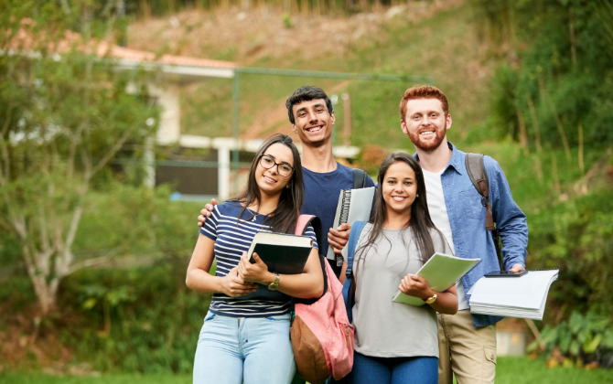 Real photo, a classroom or hallway in warm morning light — could be a teacher greeting a student at the door, or a quiet empty classroom just before the day starts