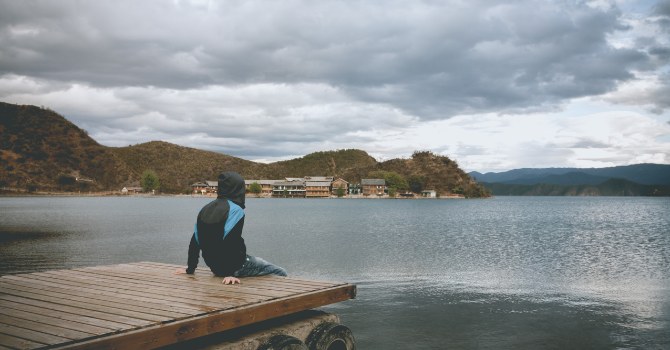 Discover how to stop overthinking and be present with practical tips and grounding exercises. Embrace mindfulness and reclaim your happiness today. A person sitting or walking quietly in nature, surrounded by soft natural light, with a calm, contemplative feeling. The image should communicate the transition from mental noise to stillness and presence.