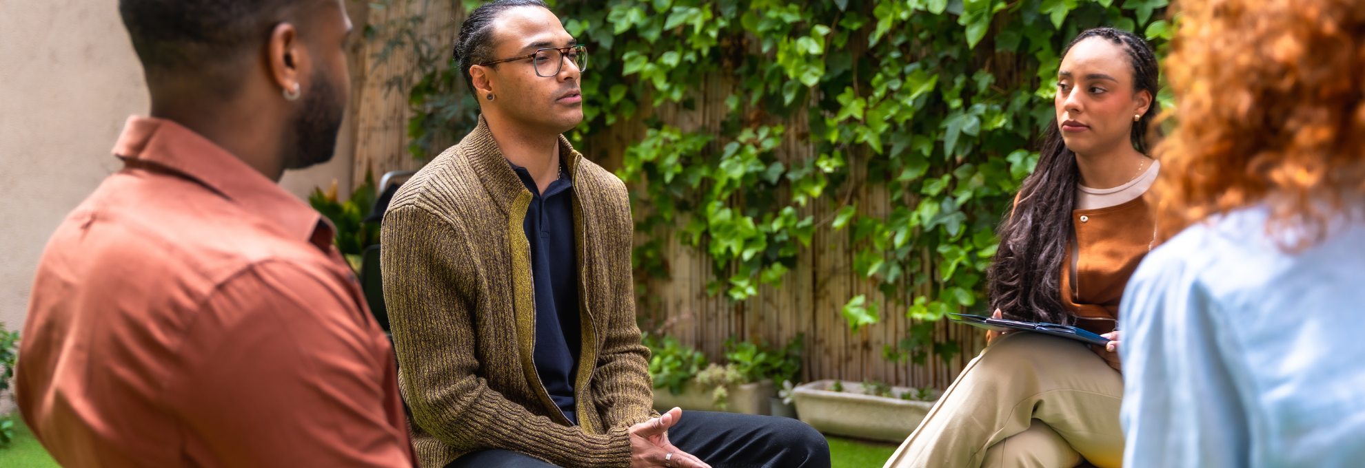 a practitioner mid-conversation with a client, a practitioner mid-conversation with a client,