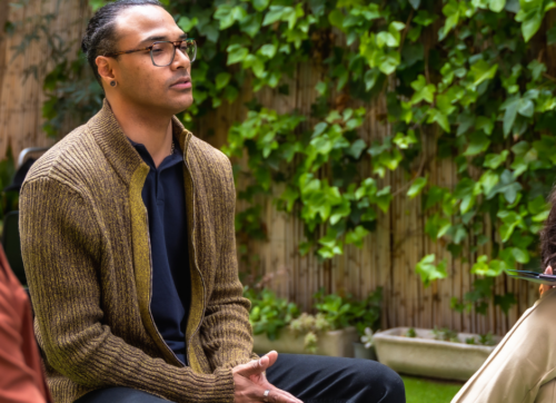 a practitioner mid-conversation with a client, a practitioner mid-conversation with a client,