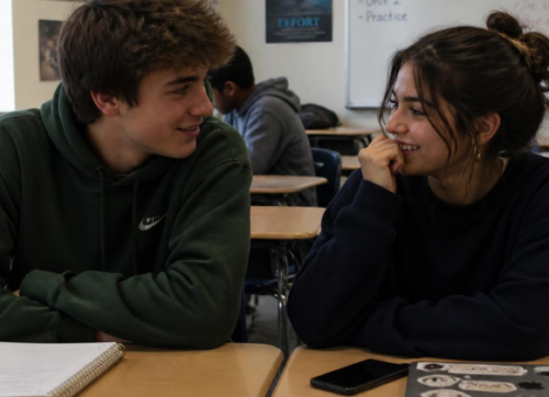 newsletter format (670 x 420 px) (16) Two students connecting naturally Two high-school students sitting together before class, talking or quietly laughing—not posed for the camera.