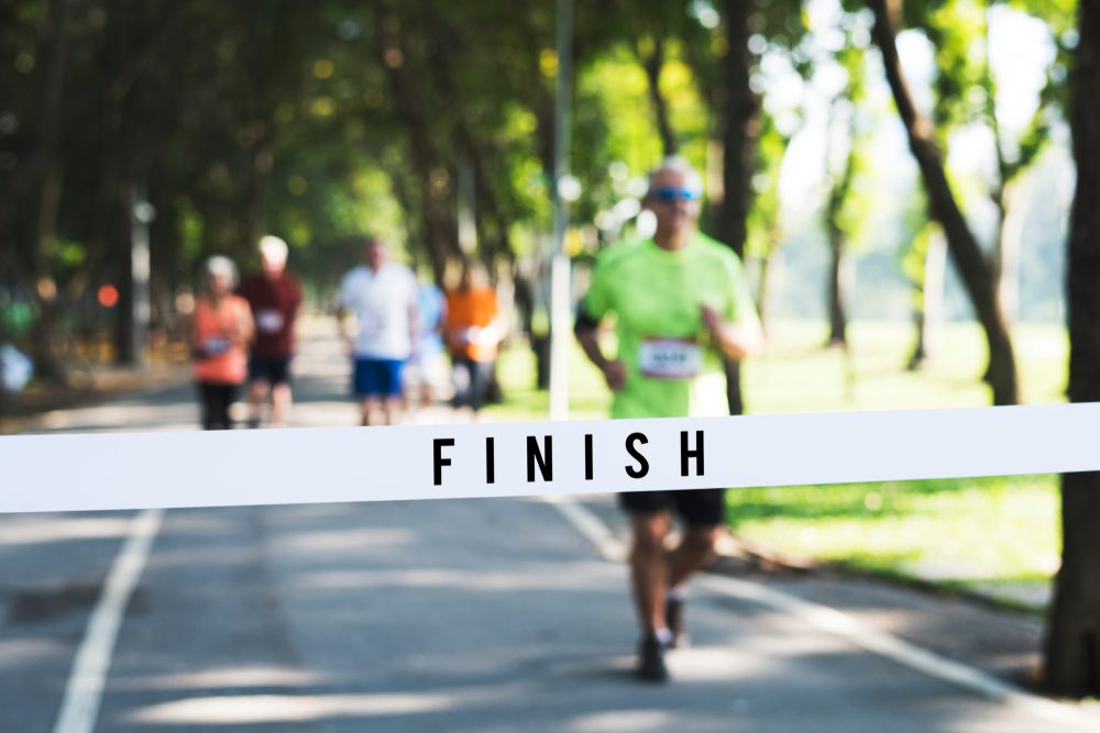 mature,man,running,towards,the,finish,line mature,man,running,towards,the,finish,line